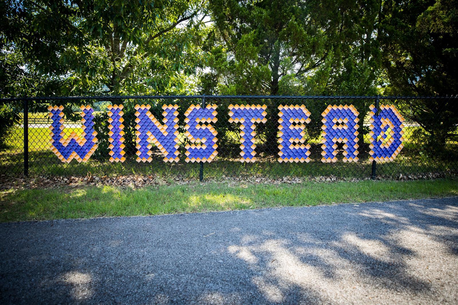 fence with sign that says winstead